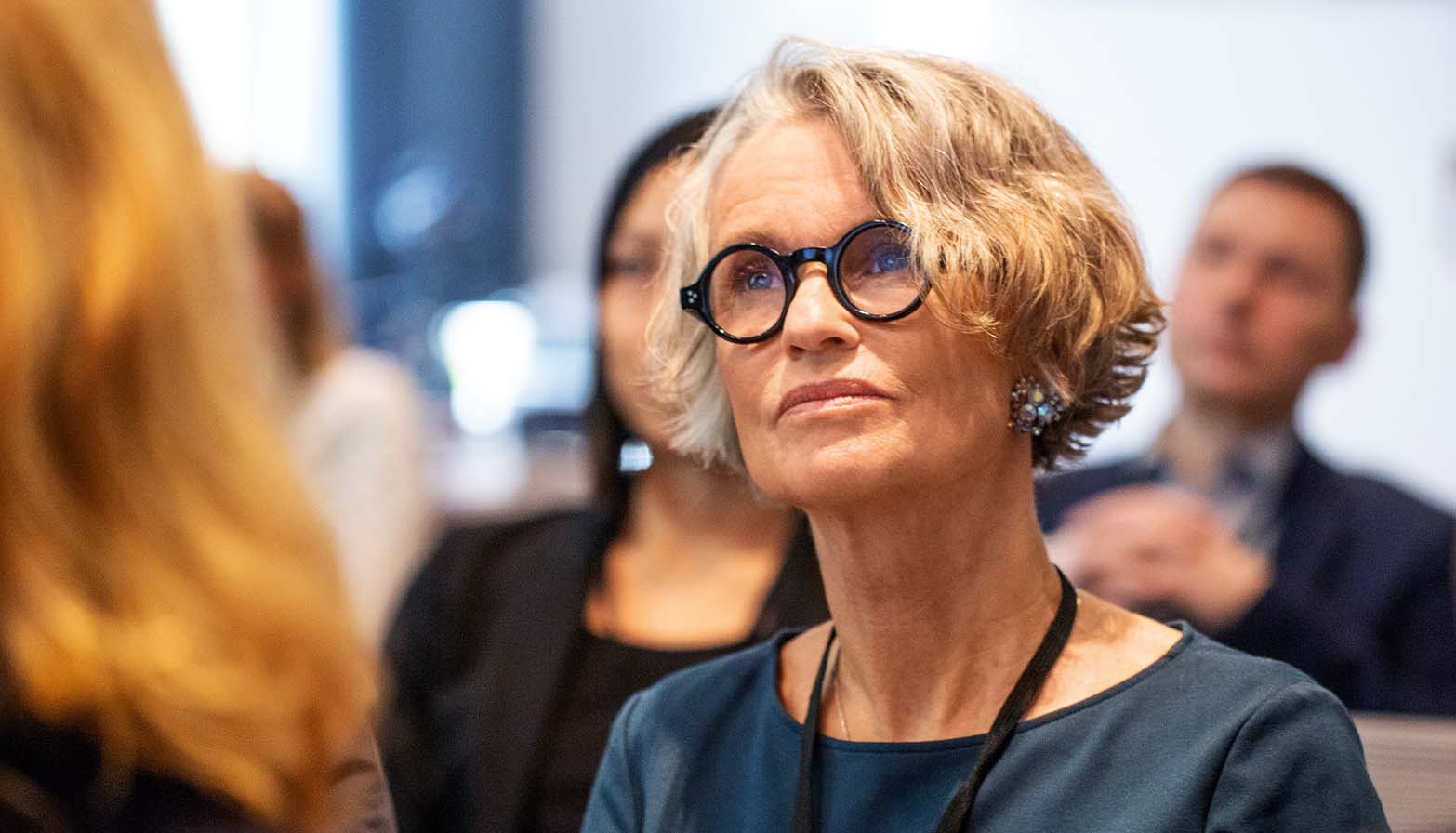 woman at conference listening to speaker