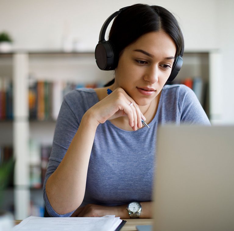 woman studying laptop headphones